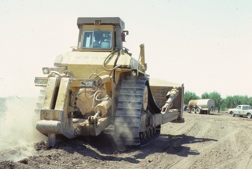 Caterpillar pulling a 5 ft soil chisler, near Patterson