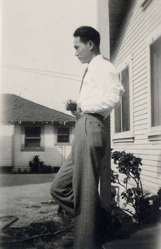 Profile of a Chinese American man standing in front of a house