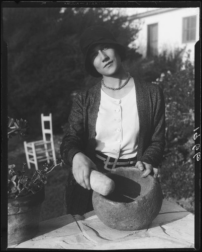 Woman with grinding stone and pestle, Palos Verdes Estates, 1930 or 1931