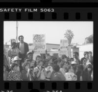 Apartheid protesters with sign reading "No Grammy to Artists Who Entertain Apartheid," outside the Grammy Awards in Los Angeles, Calif., 1985
