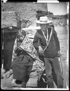 Navajo Indian father and daughter outside, ca.1900