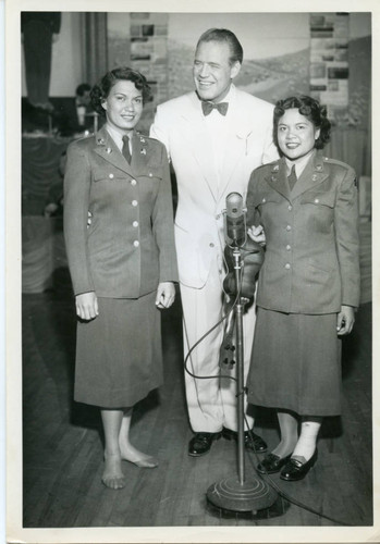Horace Heidt with two performers during the Youth Opportunity Program show at Fort Ord