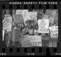Demonstrators with various anti-abortion and "In God We Trust" placards outside the 1980 Democratic National Convention in New York