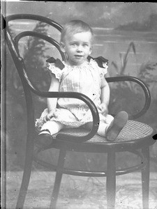 Missionary's child sitting on a chair, southern Africa