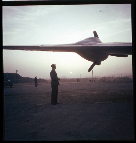 Soldier standing next to aircraft at air base