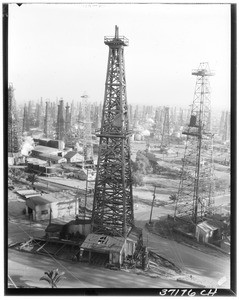 View of a single oil rig looming ahead of an oil field