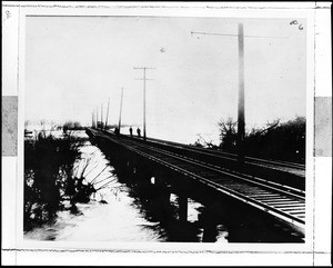 Pacific Electric railroad track looking north toward Dominguez hill during a flood of the Los Angeles River, 1914