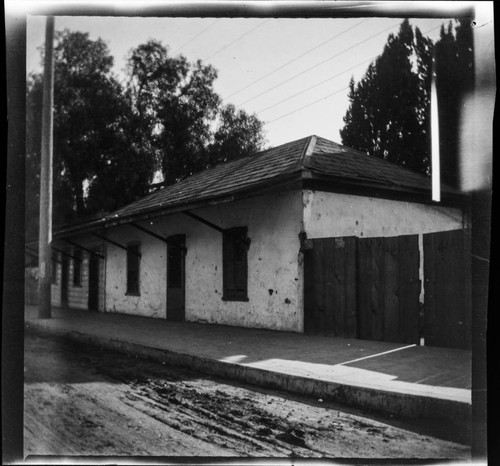 Adobe building with wooden shutters