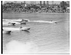 Several speedboats racing across a body of water
