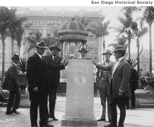 Five men standing at the Pacific Milestone in downtown San Diego