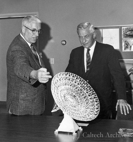 Bruce Rule and Lee DuBridge looking at model of 130' antenna