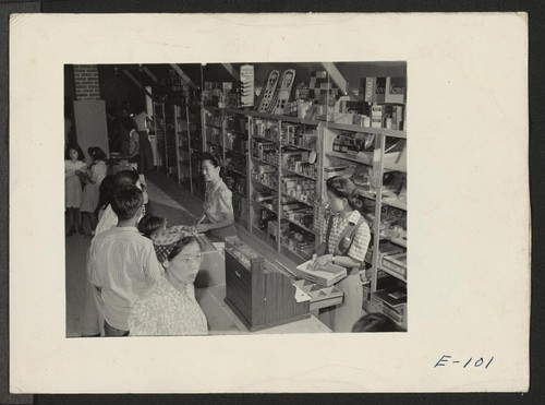 Typical scene in the Community Enterprise Stores at the Heart Mountain Relocation Center. Chief stocked item are tobacco, drug sundries