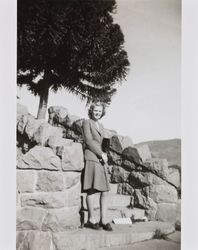 Mary McGregor standing on a stone stairway, 1941