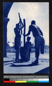 Women pounding grain while child watches, Burkina Faso, ca.1920-1940