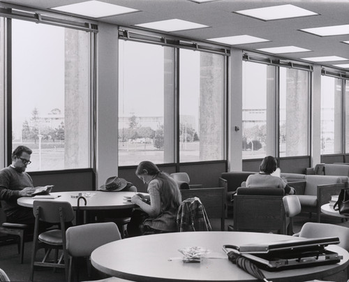 A photograph of students studying in the Library, likely on the Upper Mall on the Eastern side of the building