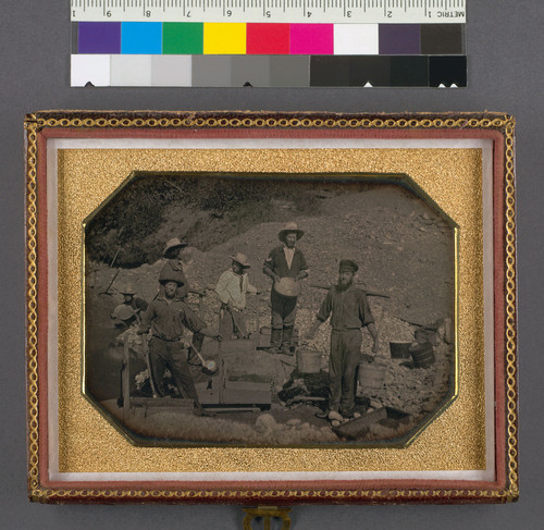 [Six miners with rocker, wheel barrows, picks, shovels and gold pans.]