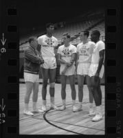 Lew Alcindor and Coach John Wooden huddle with UCLA freshman All-Americans