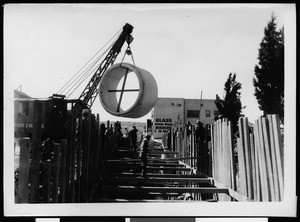 Slauson Avenue storm drain construction, showing lowering of pipe, March 6, 1936