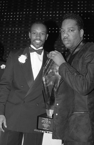 Louil Silas, Jr. posing with his "Man of the Year" award, Los Angeles, 1989