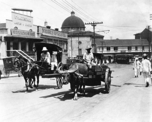 Two carriages on a Los Angeles street