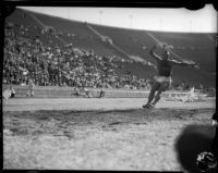 Jesse Owens competes in a long jump event at the Coliseum, Los Angeles, 1935