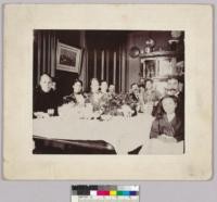 Haas family seated around a dining room table