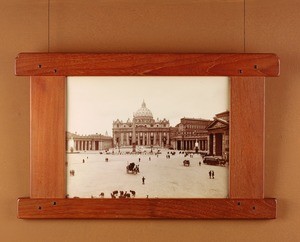 Frame enclosing a sepia-tone photograph of St. Peter's square, Rome