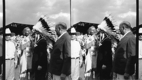 Chief Blackhorn of Sioux Tribe as he put helmet of Feathers on Balbo, Italian Flier, Century of Progress