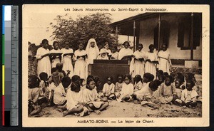 Children singing as missionary sister plays piano, Ambato-Boeny, Madagascar, ca.1900-1930