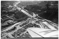 Aerial view of rushing flood waters moving down the Los Angeles River in North Hollywood, Los Angeles, 1938