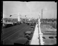 People and automobiles on Fourth St. Bridge during bridge's opening ceremony in 1931, Los Angeles, Calif