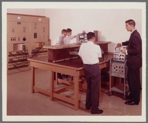 Graduate student instructs Electrical Engineering Students in Sullivan Engineering Center lab, ca. 1963