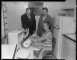 Woman using professional ironing machine in her home