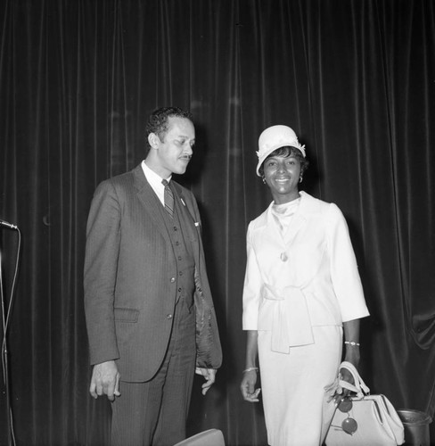 Channing E. Phillips and a woman posing together during a mayoral campaign event for Tom Bradley, Los Angeles, 1969