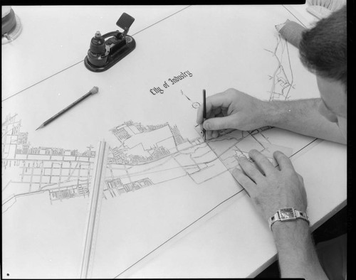 Draftsman drawing plot map for City of Industry