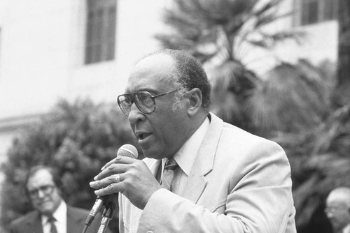 Bishop H. H. Brookins addressing a crowd in front of City Hall, Los Angeles, 1986