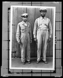Portrait of two men modeling two styles of uniform for the Refuse Collection Division in Los Angeles, 1920-1930