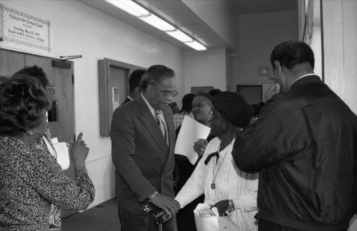 Older women greeting man at Grant A.M.E. Church during a conference, Los Angeles, 1997
