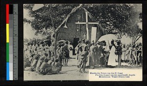 Missionary fathers gathered with villagers in front of a cross, Angola, ca.1920-1940