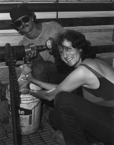 On board the D/V Glomar Challenger (ship) geochemist Miriam Kastner from Scripps Institution of Oceanography and another crew member collecting H2O from Site 504B of the Deep Sea Drilling Project. 1983