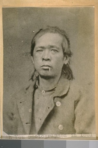 Ah You photographed in 1861. [Adjacent caption reads: "This is a photographic copy of the record and photo of the first Chinese arrested in San Francisco in 1861 for Petite Larceny. He was photoed [sic] the first day the Police Gallery opened in the old City Hall S.E. cor. Washington and Kearny Sts. In 1861.]