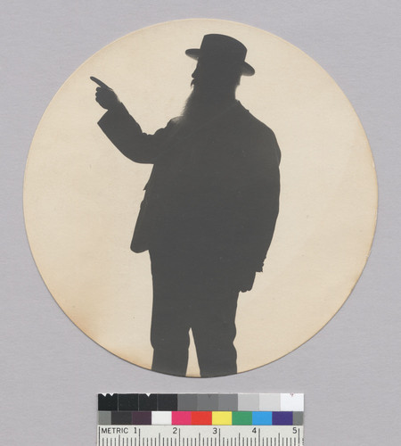 Three-quarter length silhouette of man pointing, Bohemian Grove. [photographic print]