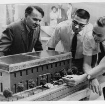 Group view from the left, R. Burnett Miller, president of the Sacramento Historic Landmarks Commission receiving a scale model of the old city hall and waterworks building