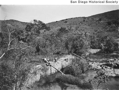 People standing on the ruins of the Old Mission Dam