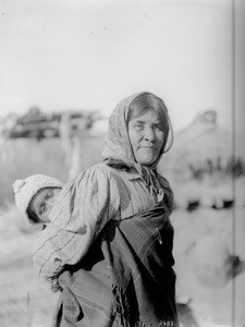 Chemehuevi Indian woman carrying a child on her back, ca.1900