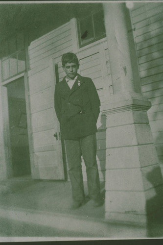 Young man of the Marquez Family standing on a porch in Santa Monica Canyon