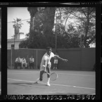 UCLA tennis player Arthur Ashe firing a backhand volley at Dennis Ralston in Southern California Intercollegiates, 1964