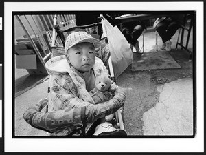 Young boy of Chinese origin sitting in a stroller, Cameron House, Chinatown, San Francisco, California, 2002