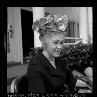 Ivy Baker Priest, the former treasurer of the United States wearing hat made of dollar bills, 1965
