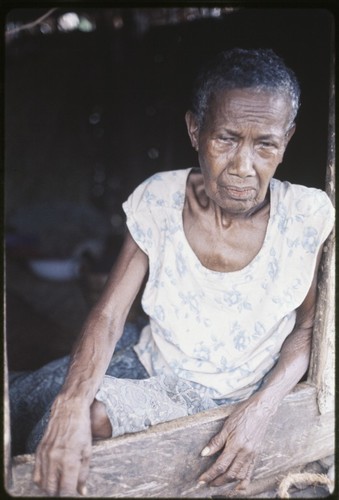 Elderly woman, Bomtavau, in a doorway
